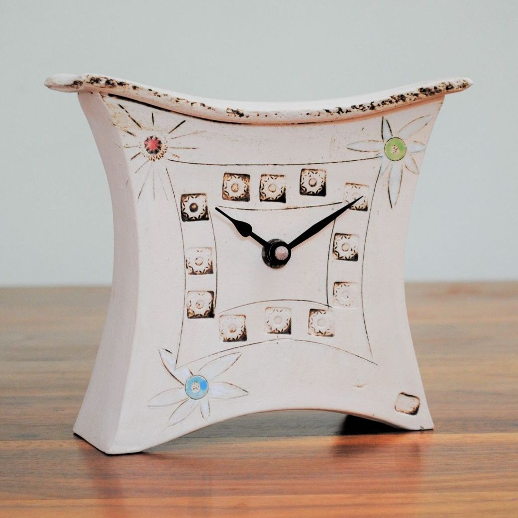 Handmade ceramic mantel clock from a white clay and decorated with daisy