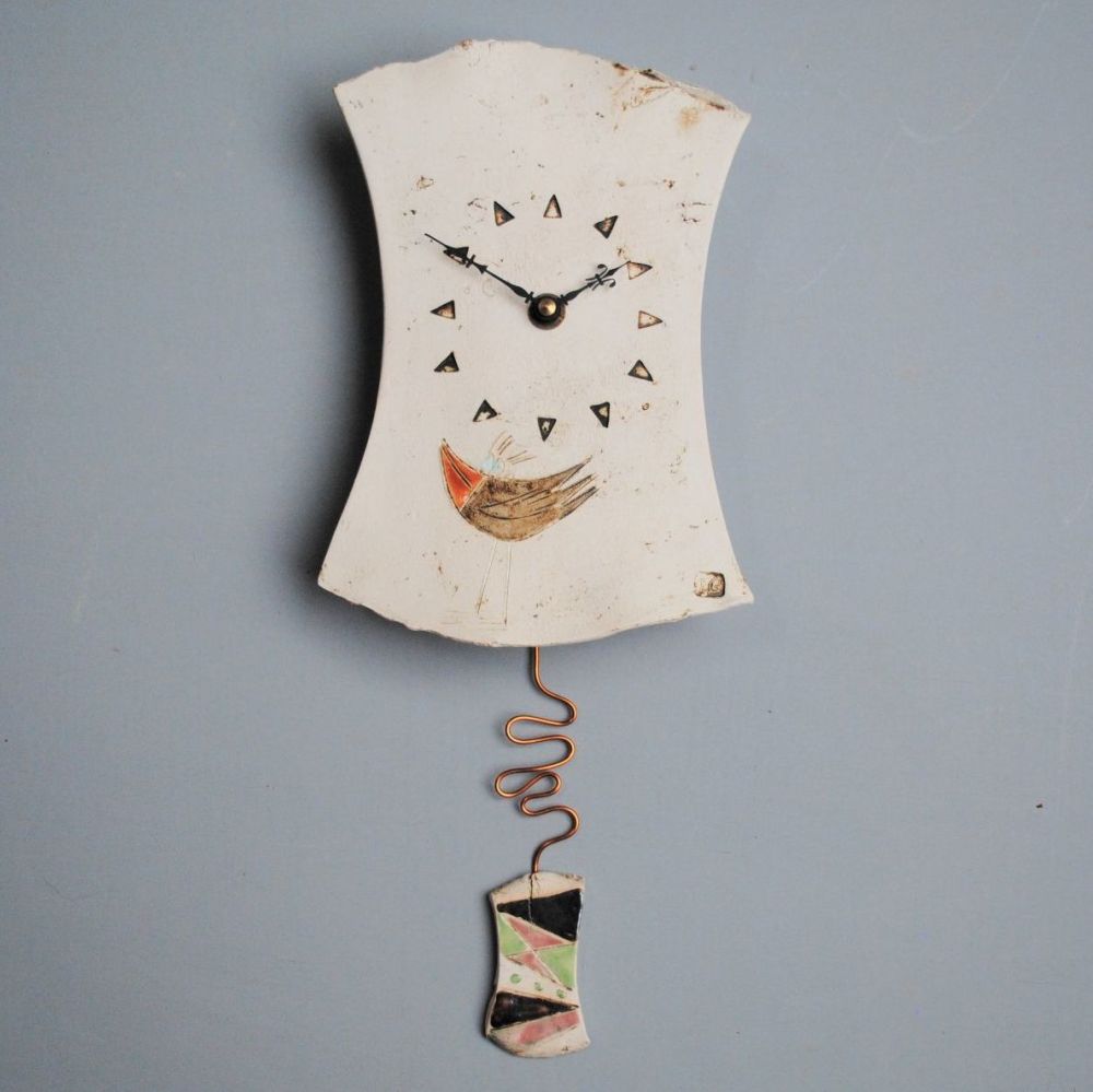 Ceramic pendulum wall clock with bird.