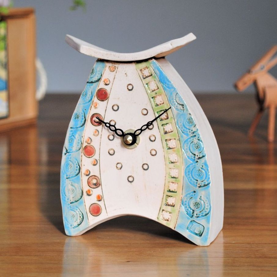 Handmade ceramic mantel clock from off-white clay, painted with green, blue