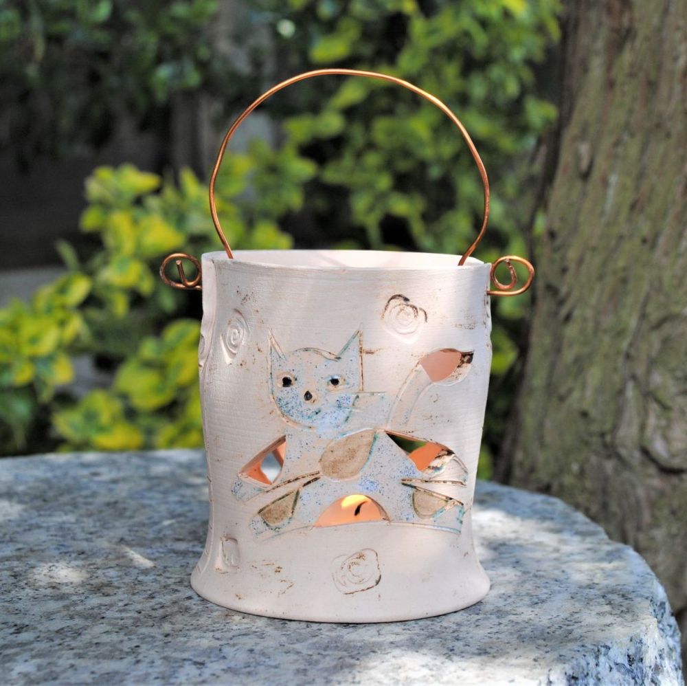 Unique ceramic tea light holder with cat design.