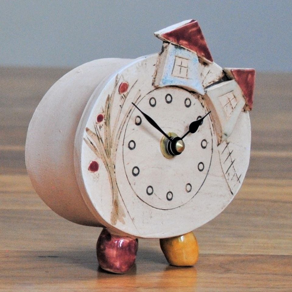 Unique handmade ceramic clock with tree and house design. 