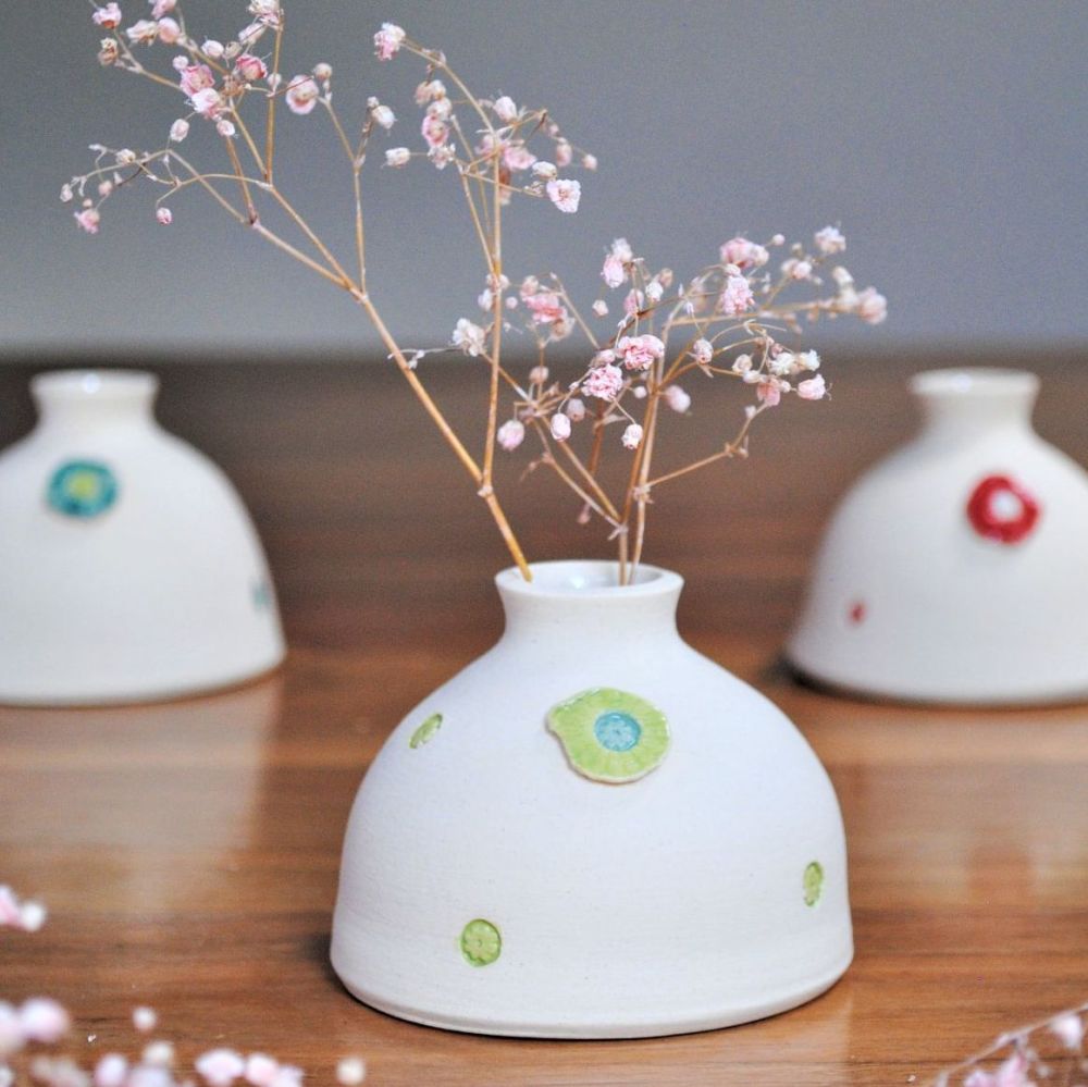 Cerami white bud vase with lime green detials.