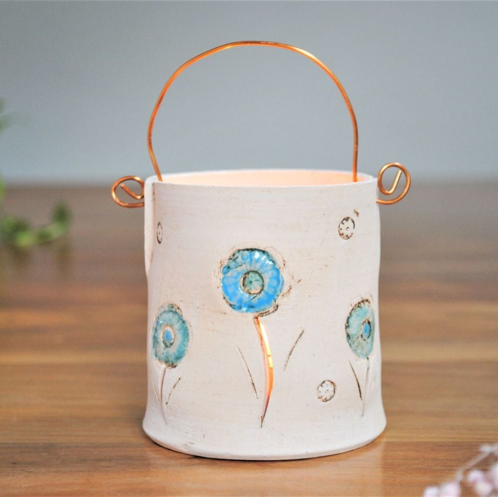 Tea light with copper wire and flower blue button print.