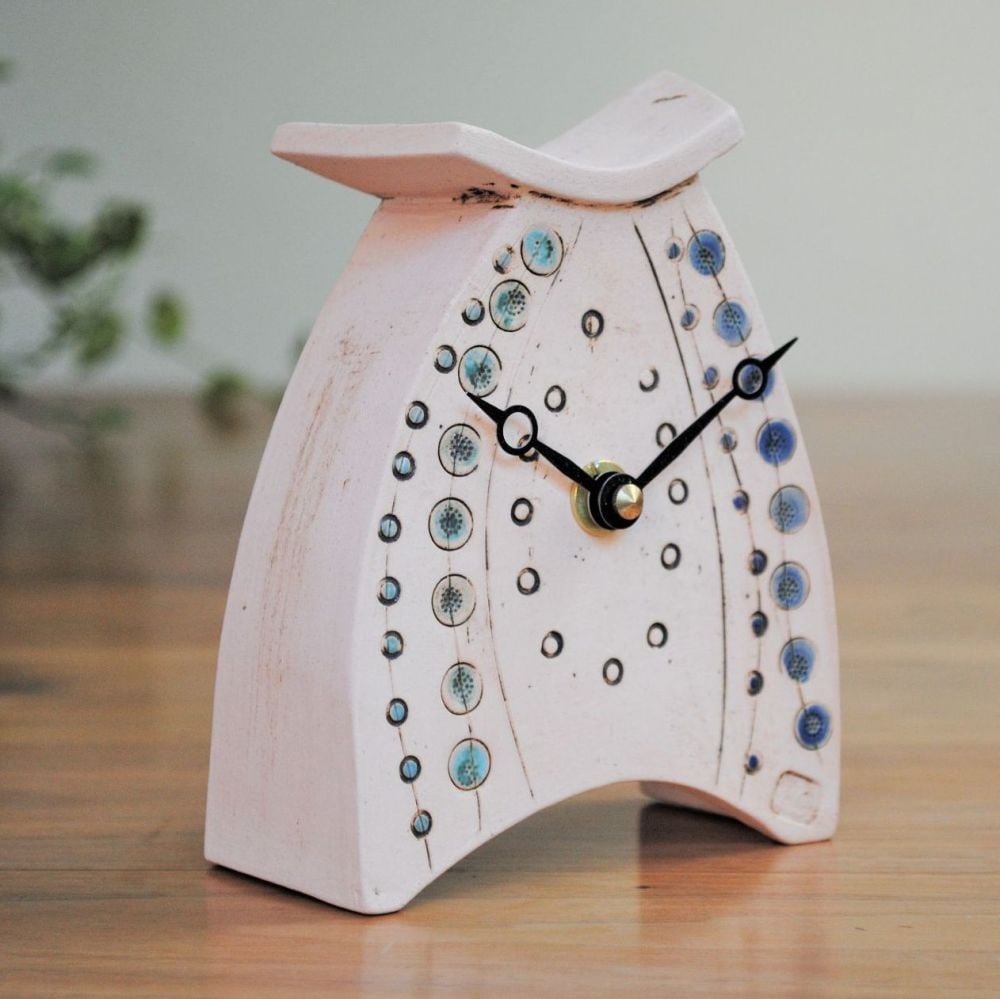 Mantel handmade ceramic clock with blue details.