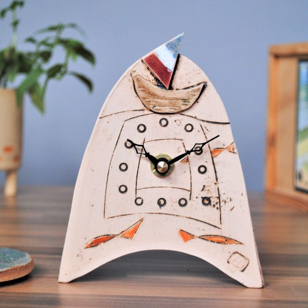 hnadmade clock with boat and fish.