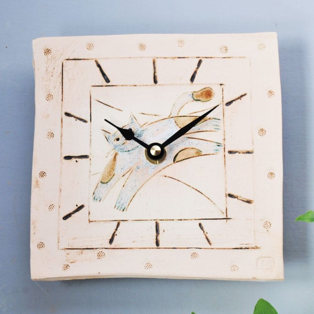 Handmade ceramic square wall clock with cat motif.