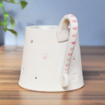 Jug with pink detailed handle.