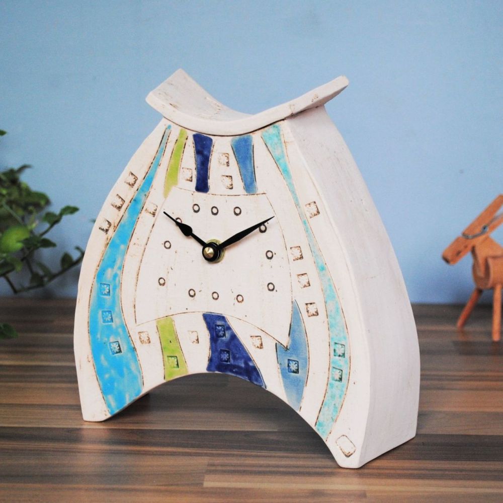 Handmade ceramic clock with blue and green glaze.