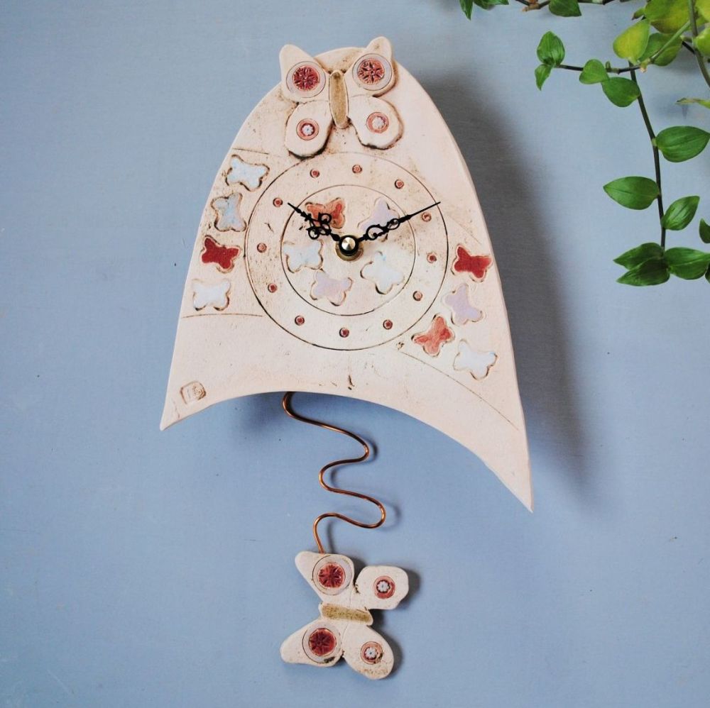 Butterfly pendulum wall clock.
