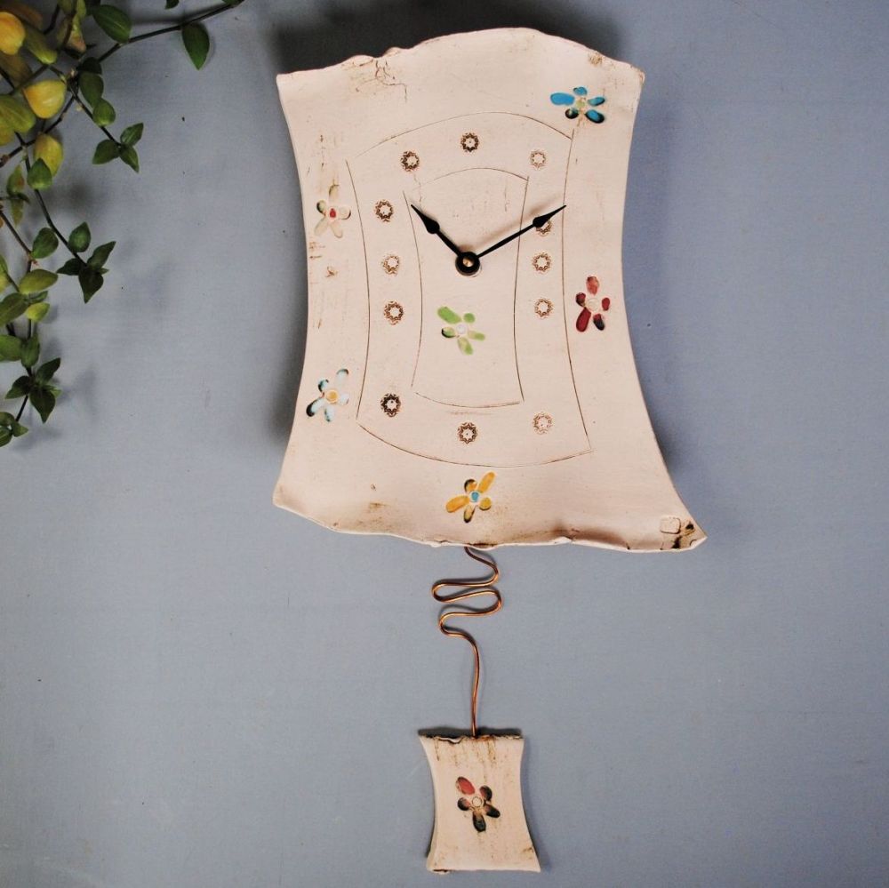 Ceramic pendulum wall clock with flower print.