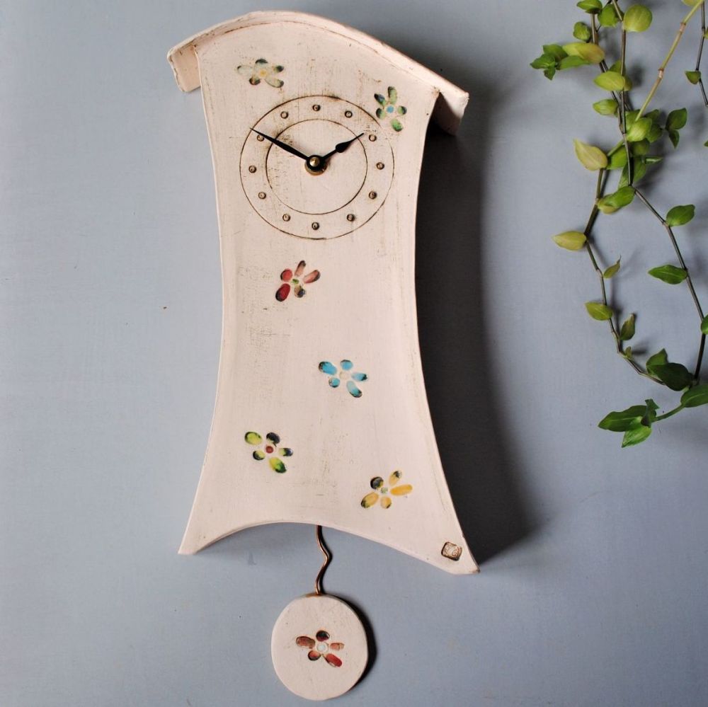 ceramic handmade wall clock wiht bright coloured flowers