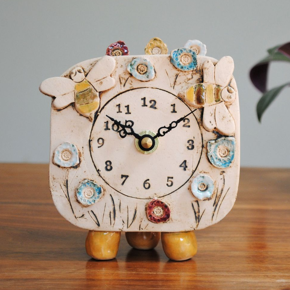 Small mantel clock with bees and meadow.