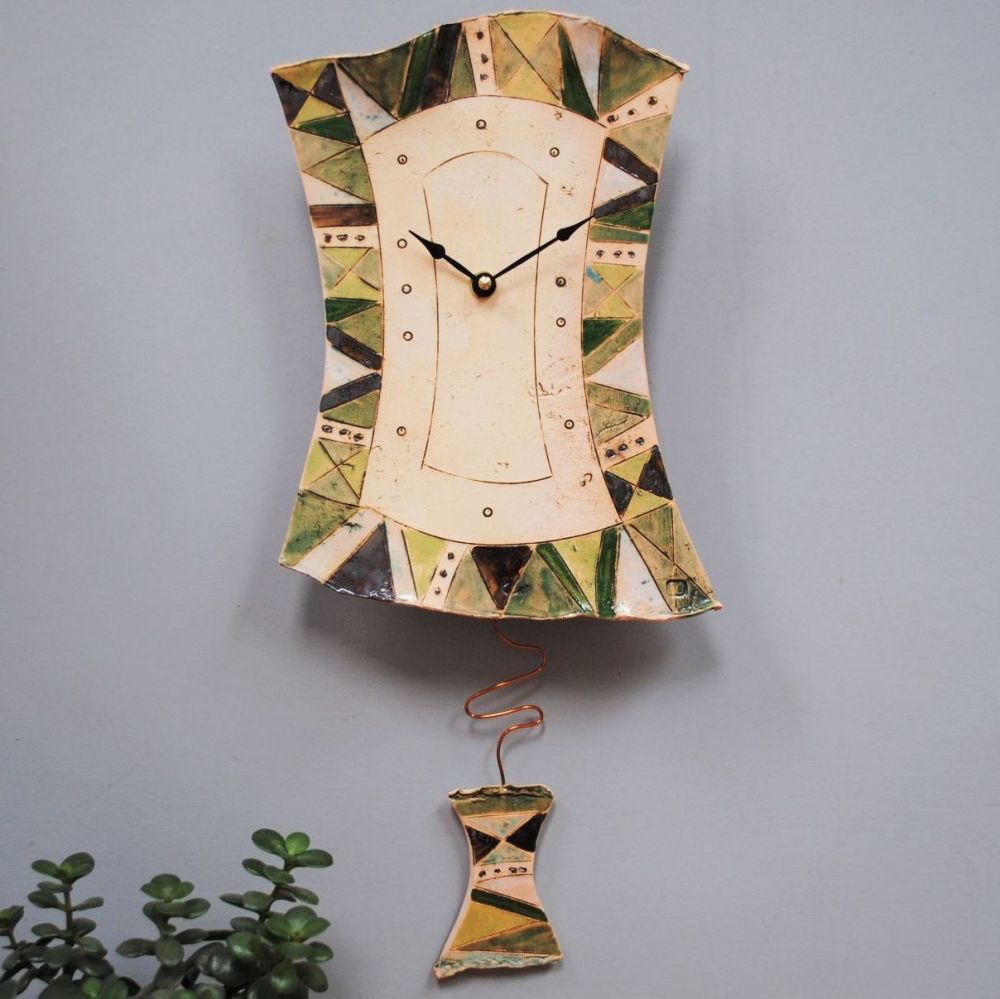 Ceramic pendulum wall clock with green contemporary design. 