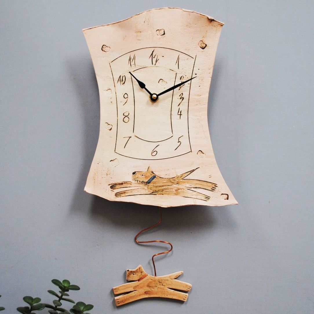 Dog wall clock with pendulum.