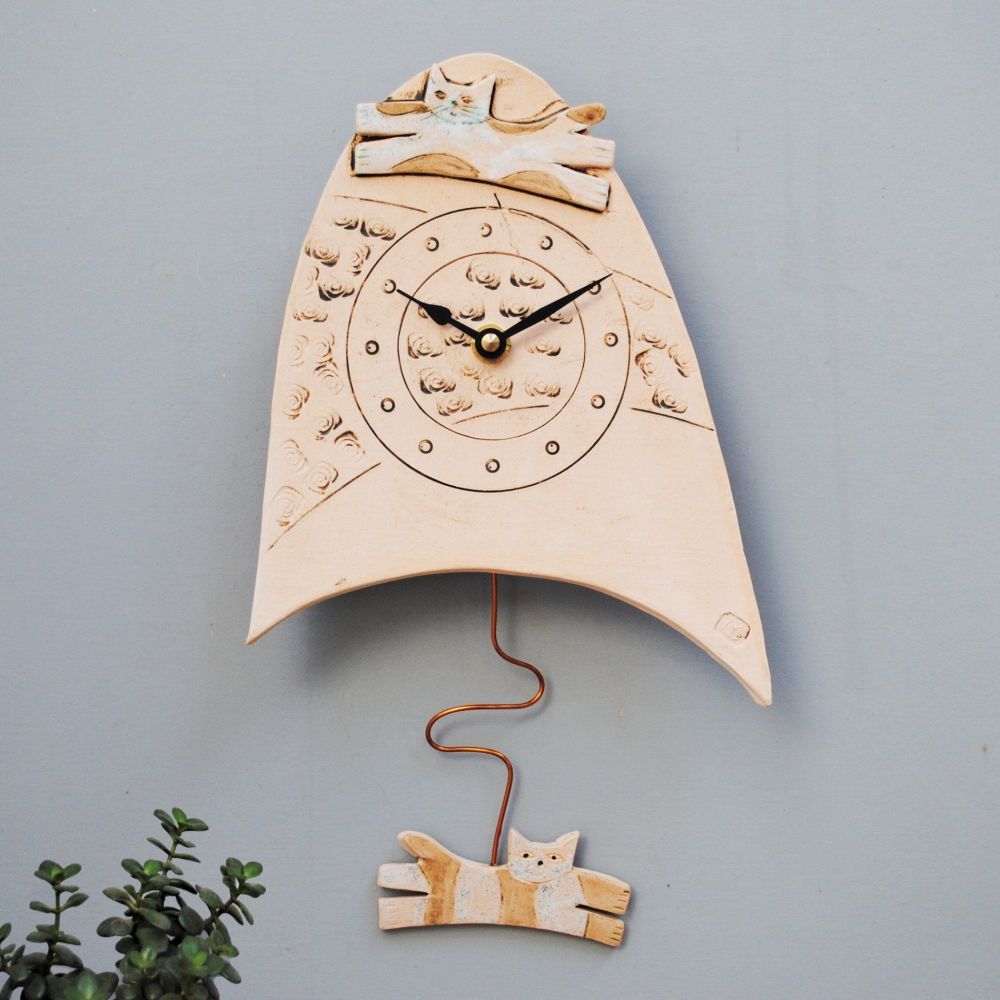 Pendulum wall clock with cat design.