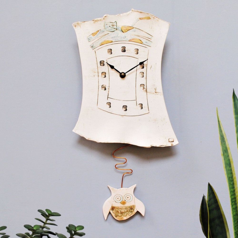 Pendulum wall clock with cat and owl.