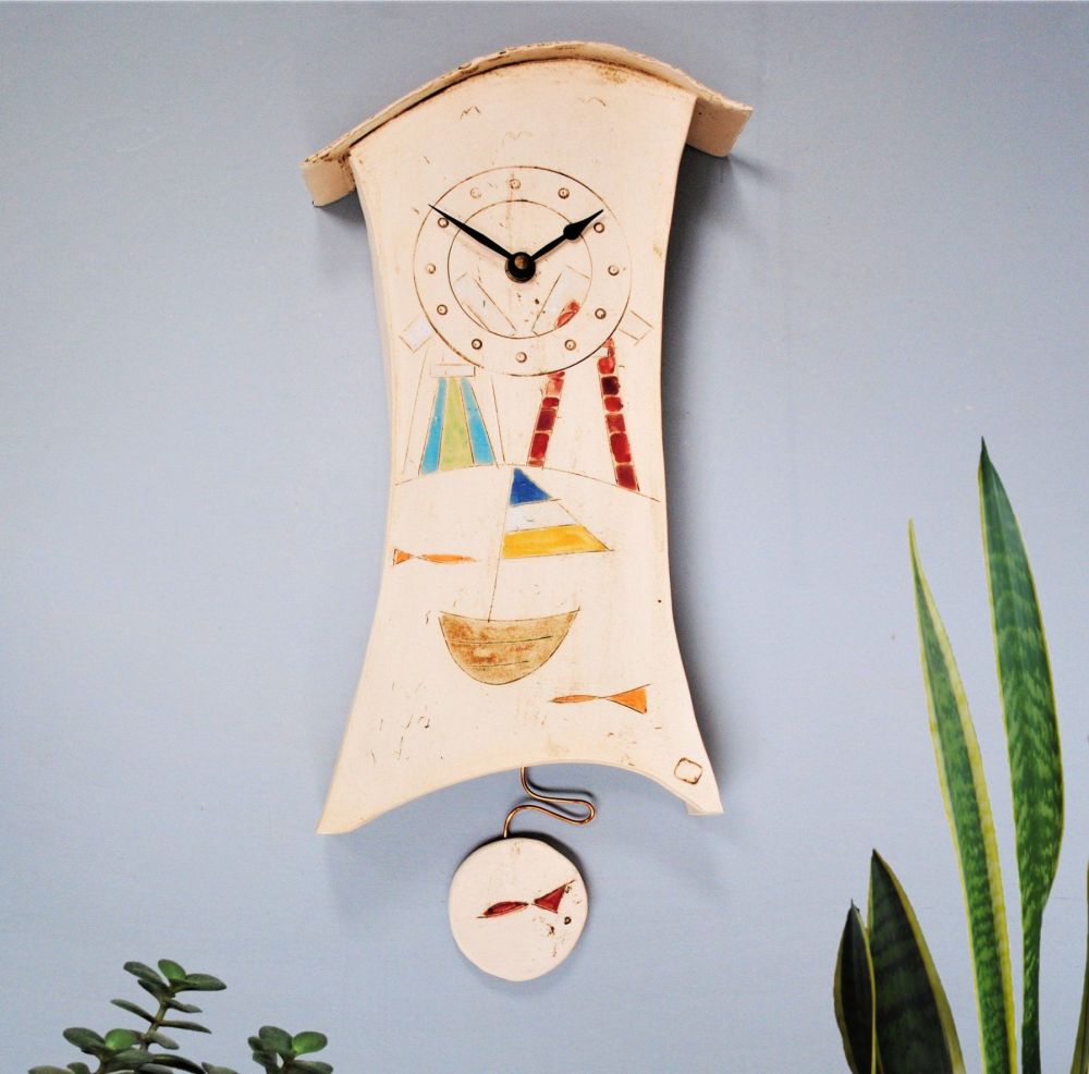 Wall clock with pendulum, seaside motif.
