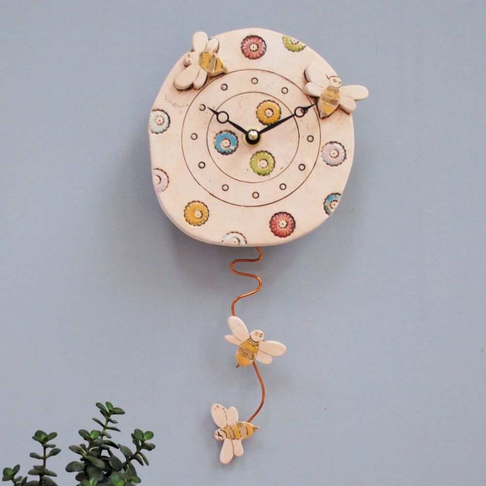 Bee wall clock with bright coloured meadow