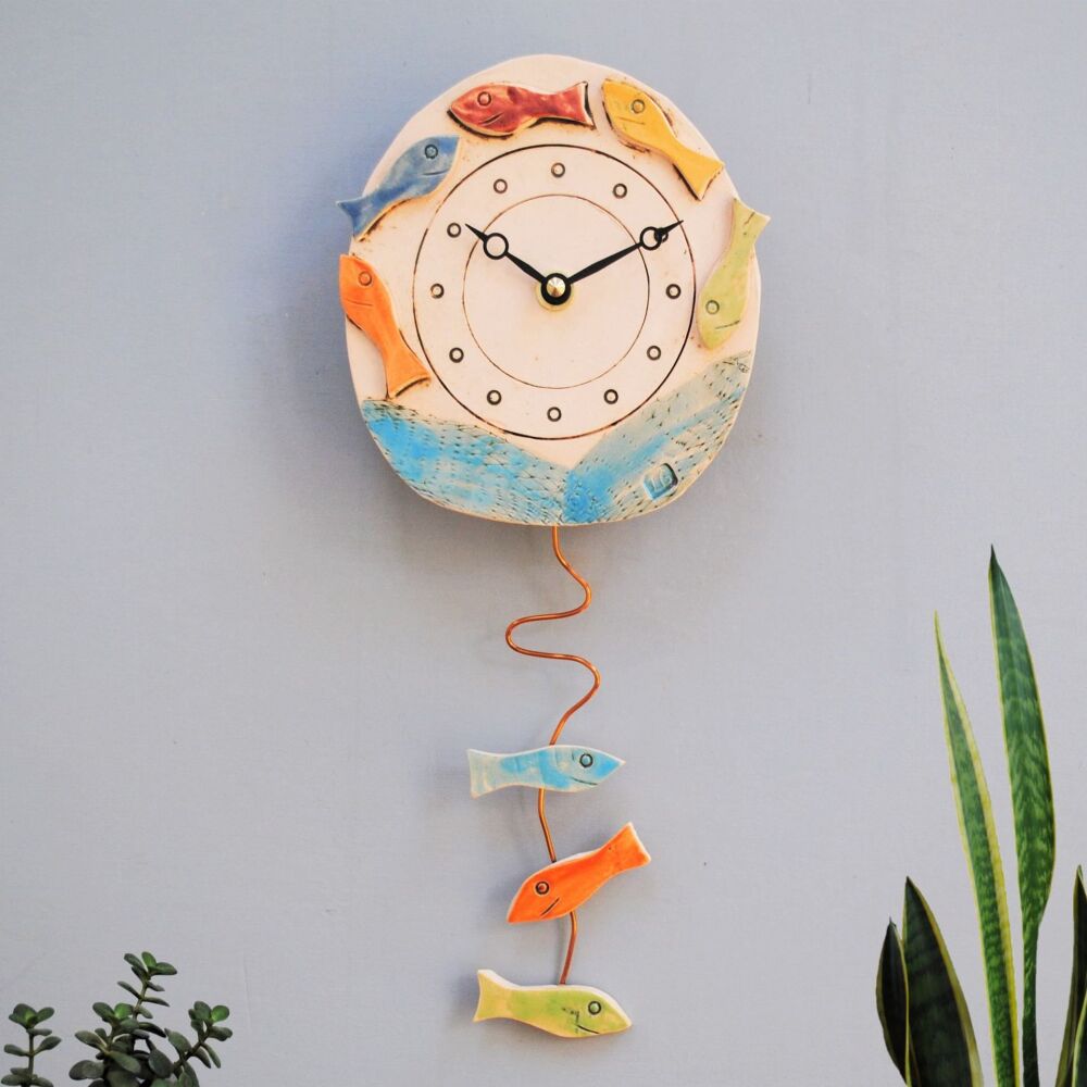 Nautical themed wall clock with bright coloured fish shoal..