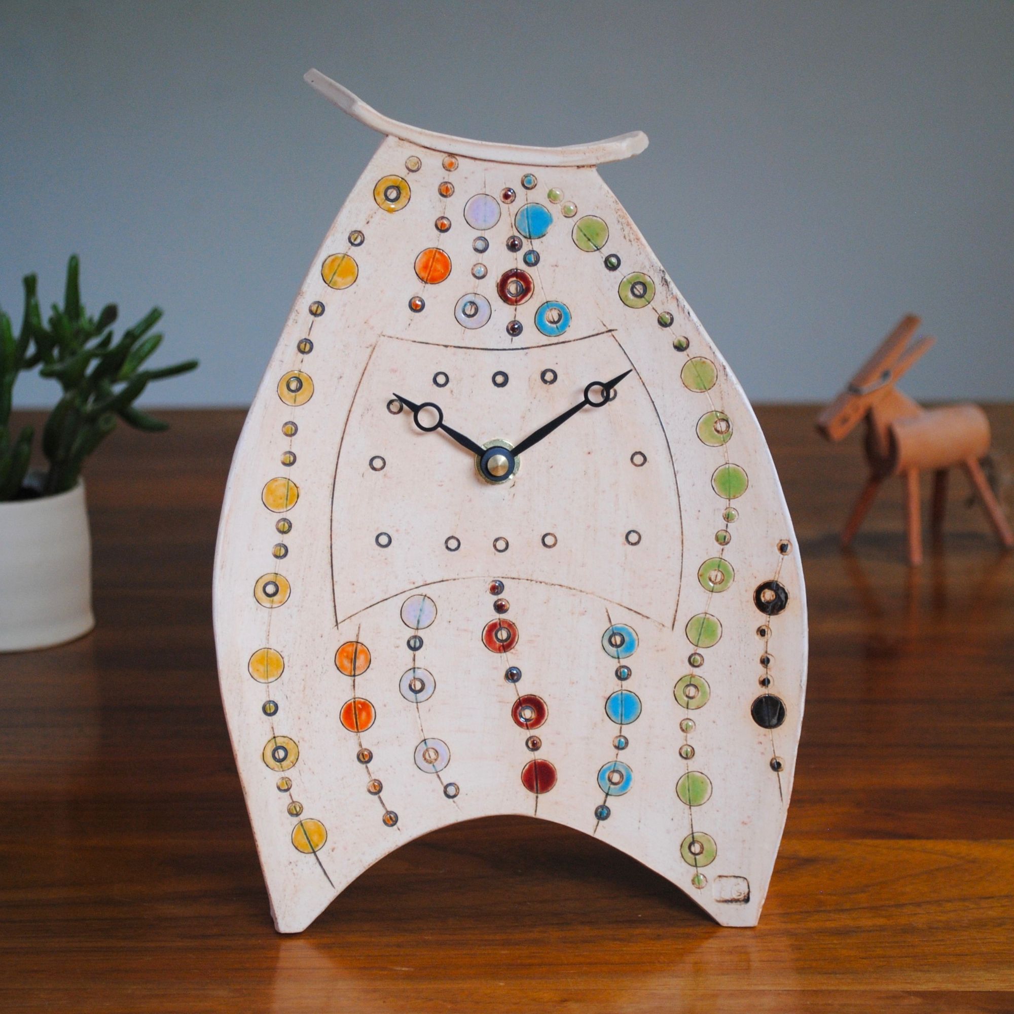 large mantel clock with bright coloured dots