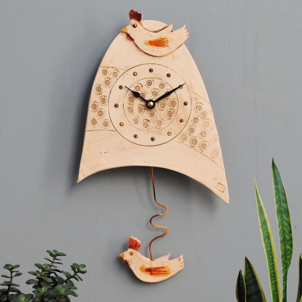 Chicken and Cockrow pendulum wasll clock in off white clay. 