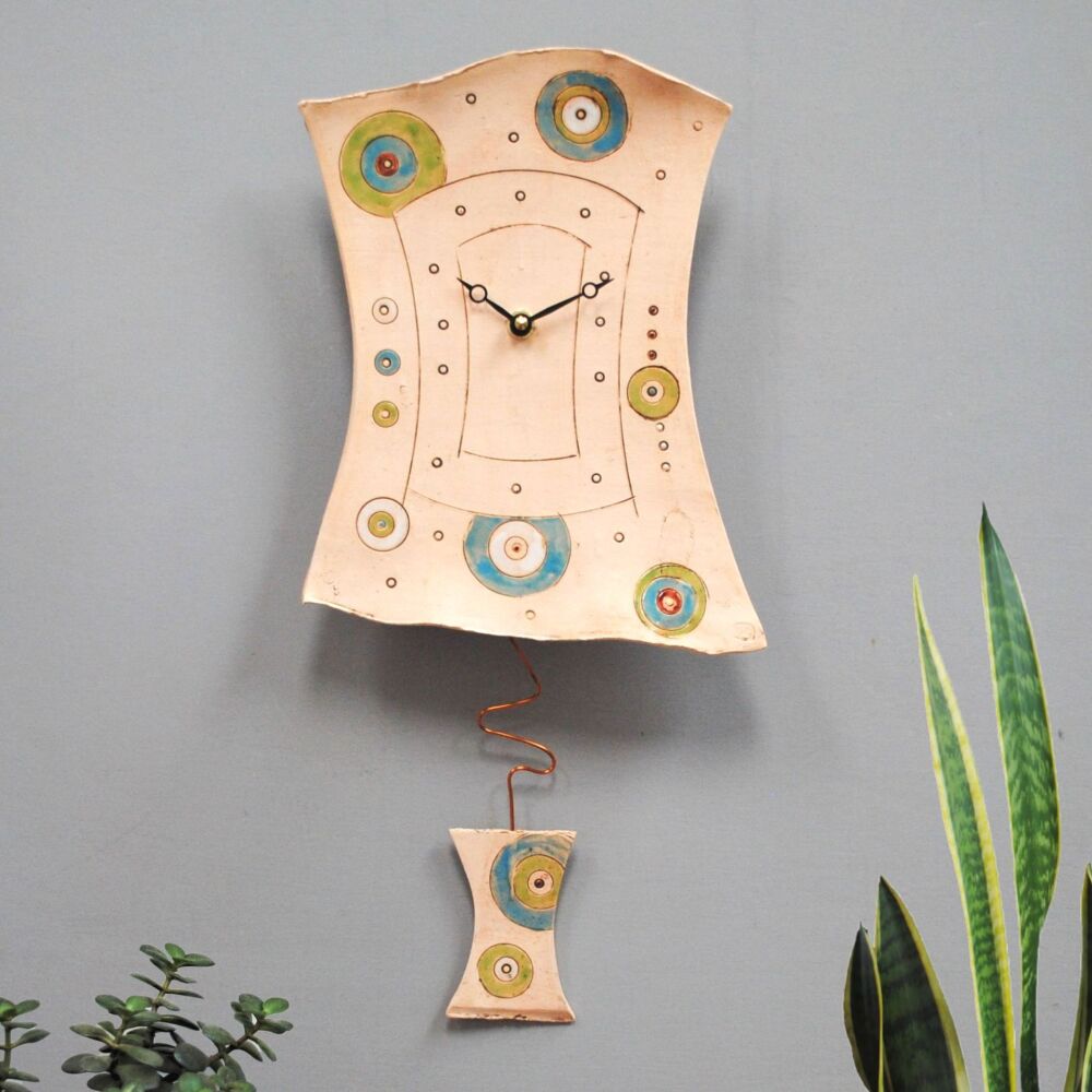 Geometric design clock with green and blue circles.