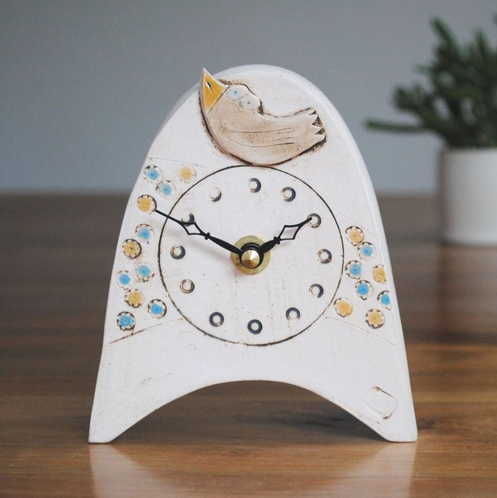 Birdwatch handmade clock with bird and meadow.