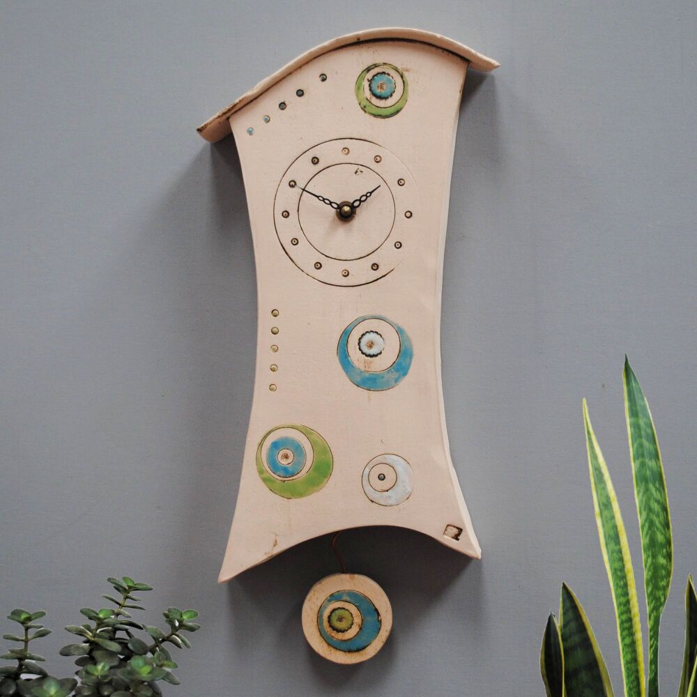 Circles in blue, green, white ceramic wall clock with pendulum.