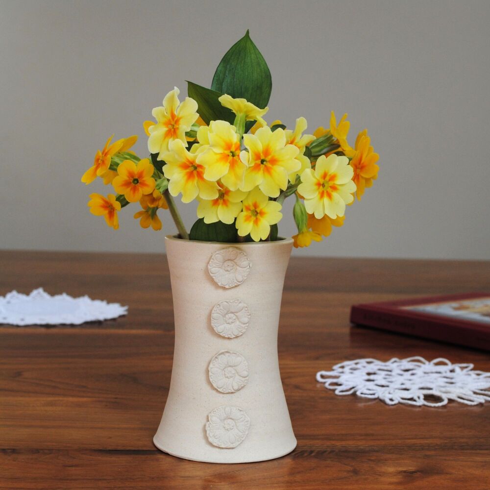 Elegant white cotton ceramic vase with flower blossoms.