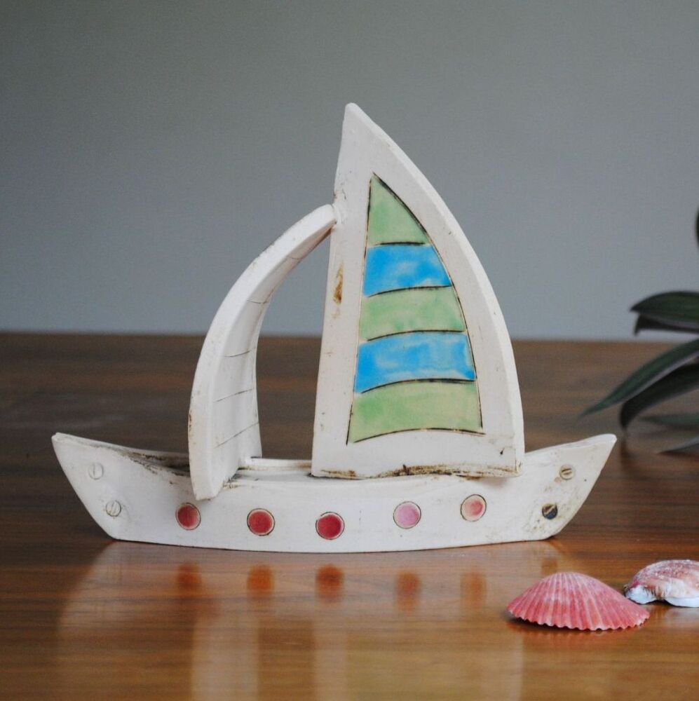 Sailing boat in blue and gree.