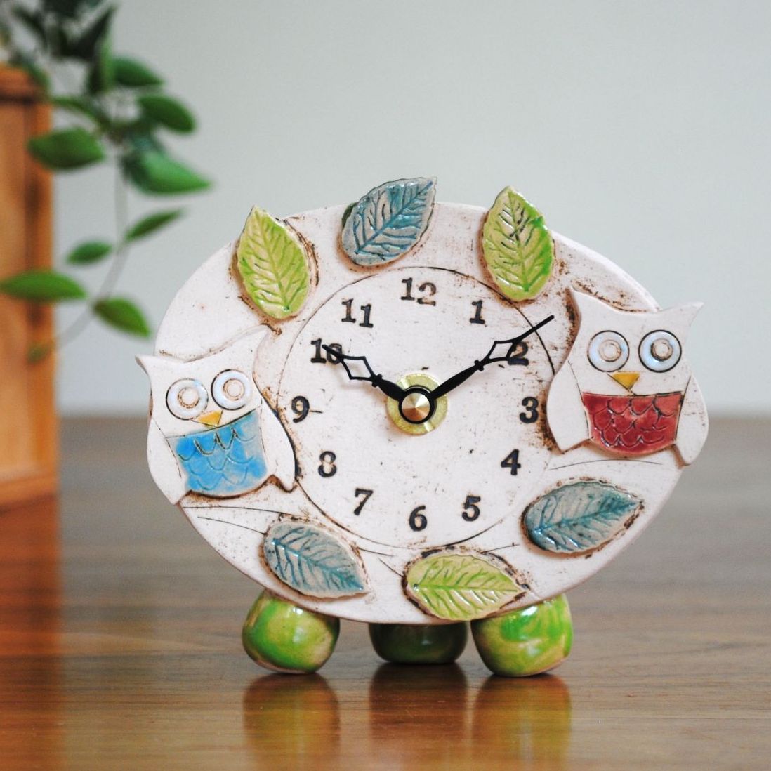 Two owls ceramic clock with pebble feet.