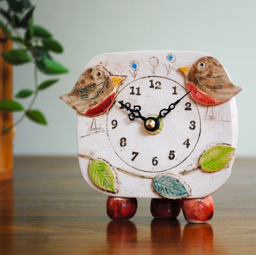 Ceramic clock with robin, leaves and flowers.