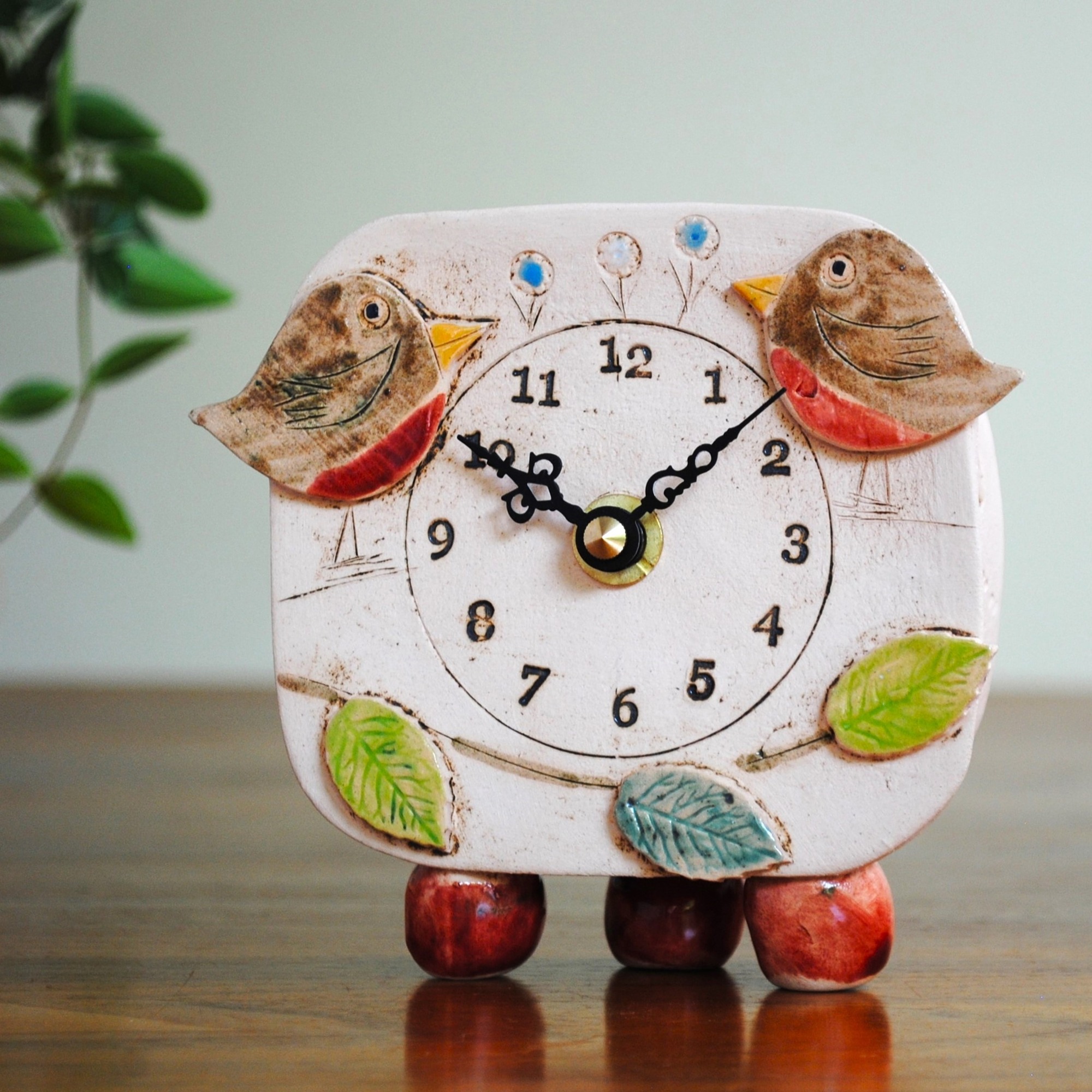 Small mantel clock with bees and meadow.