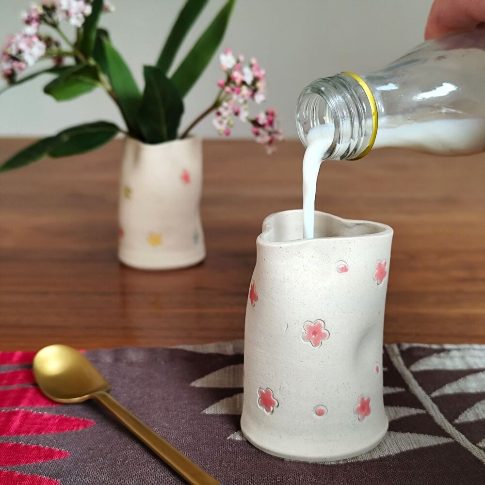 Heart shaped jug with pink flowers.