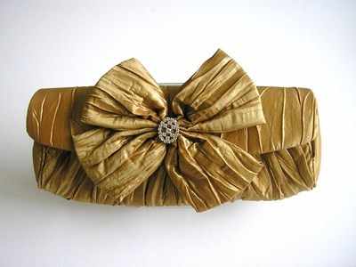 Designer evening clutch bag.metallic gold.large bow,jewel 