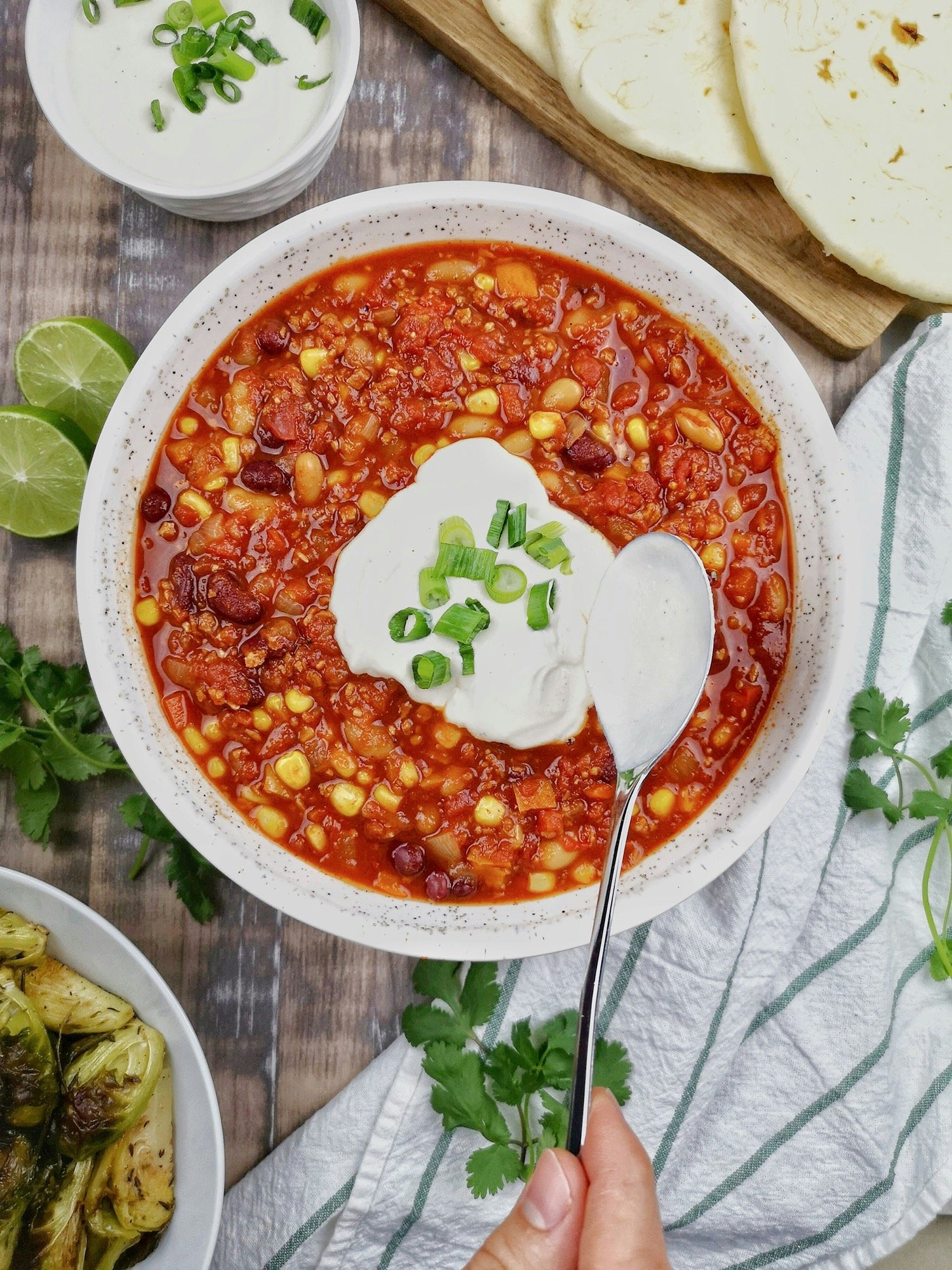 a-bowl-of-chili-with-sour-cream-on-top-SlqbDPH6Bic