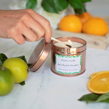 Lime, Basil &amp; Mandarin candle tin being lit