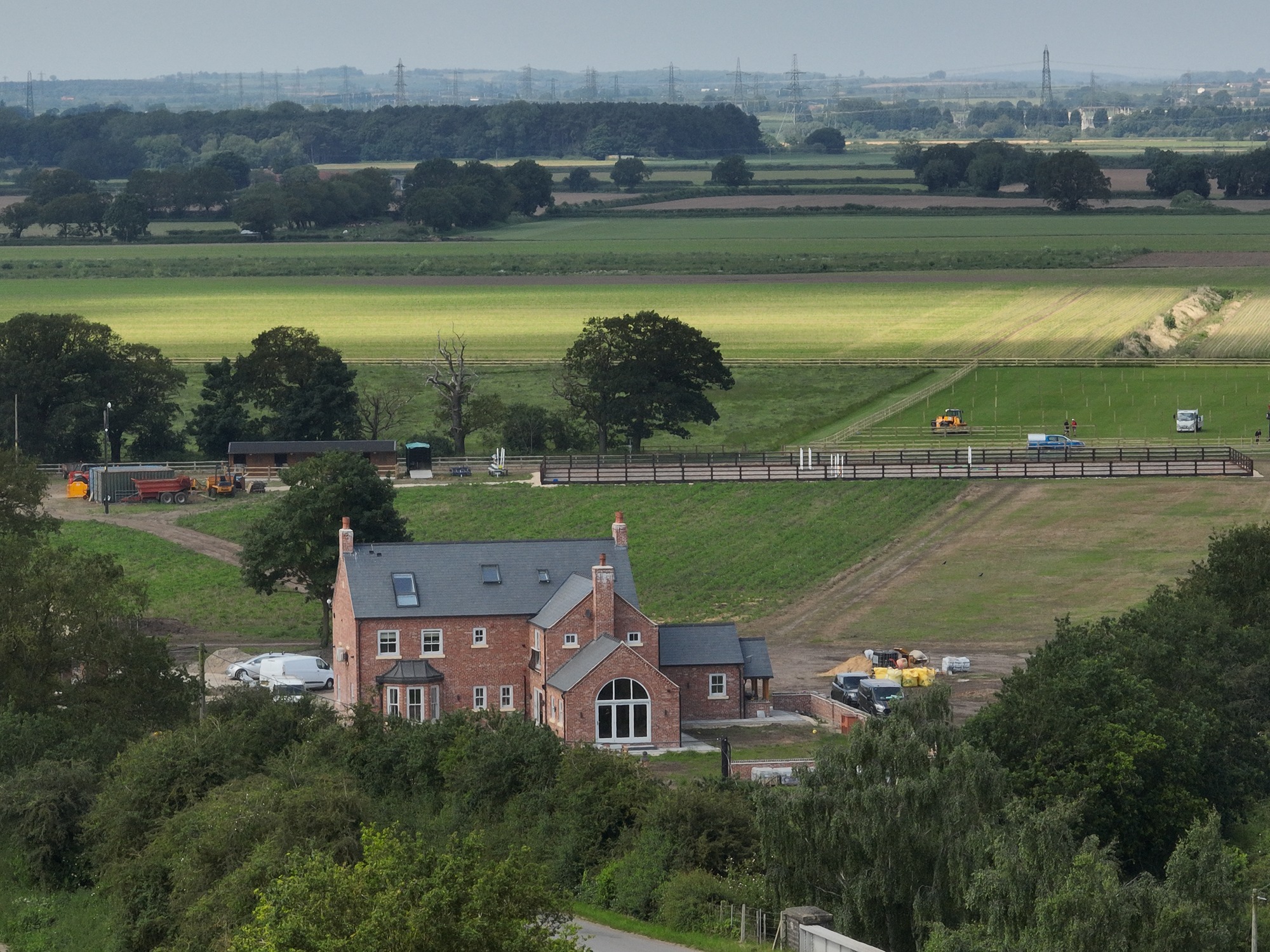 Aerial view of Carr Farm, Thorney, showing new farmhouse, outbuildings, equestrian areas, and landscaped grounds