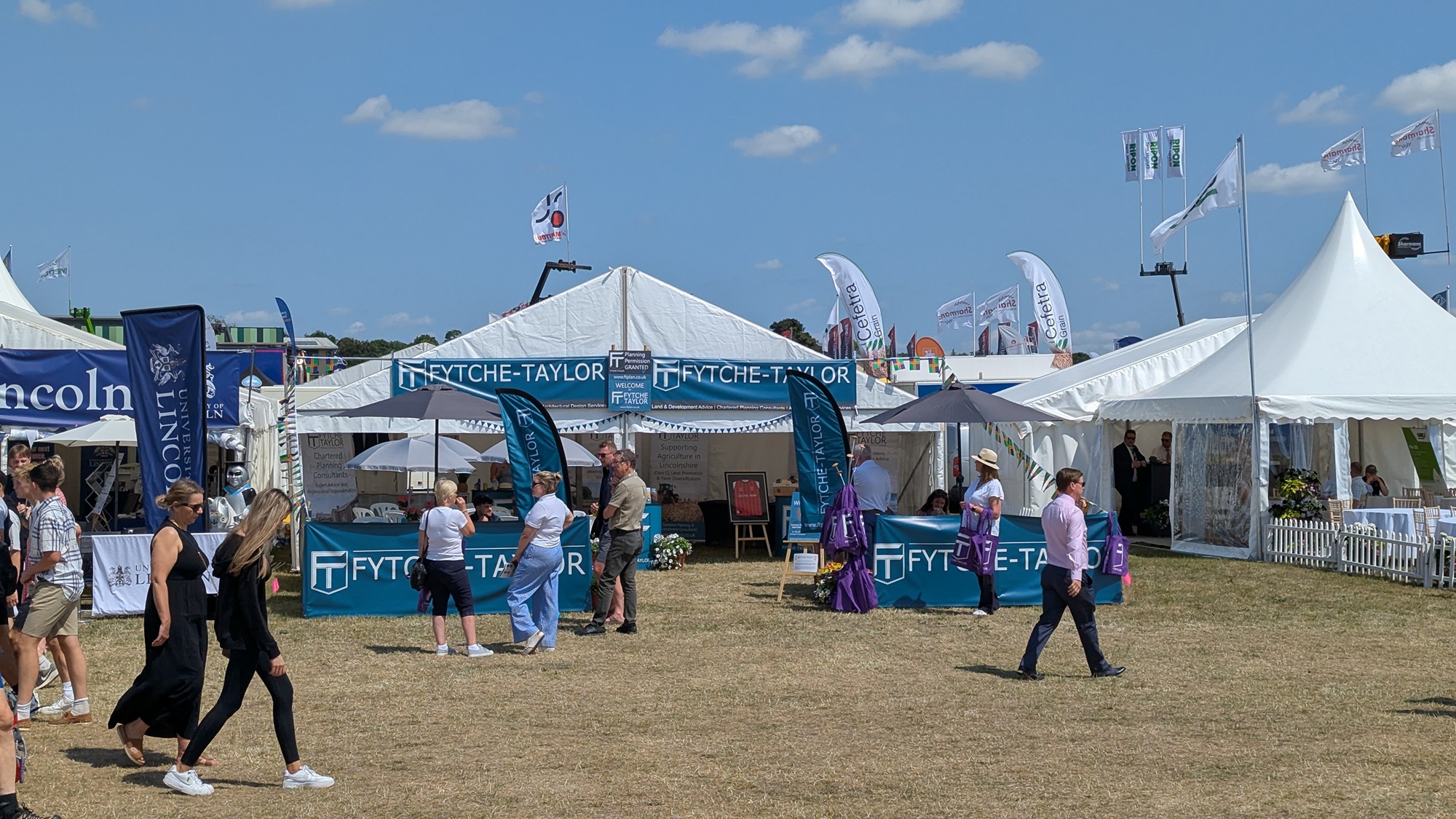 Lincolnshire Show visitors gathering at the Fytche-Taylor Planning exhibition stand near the Main Ring