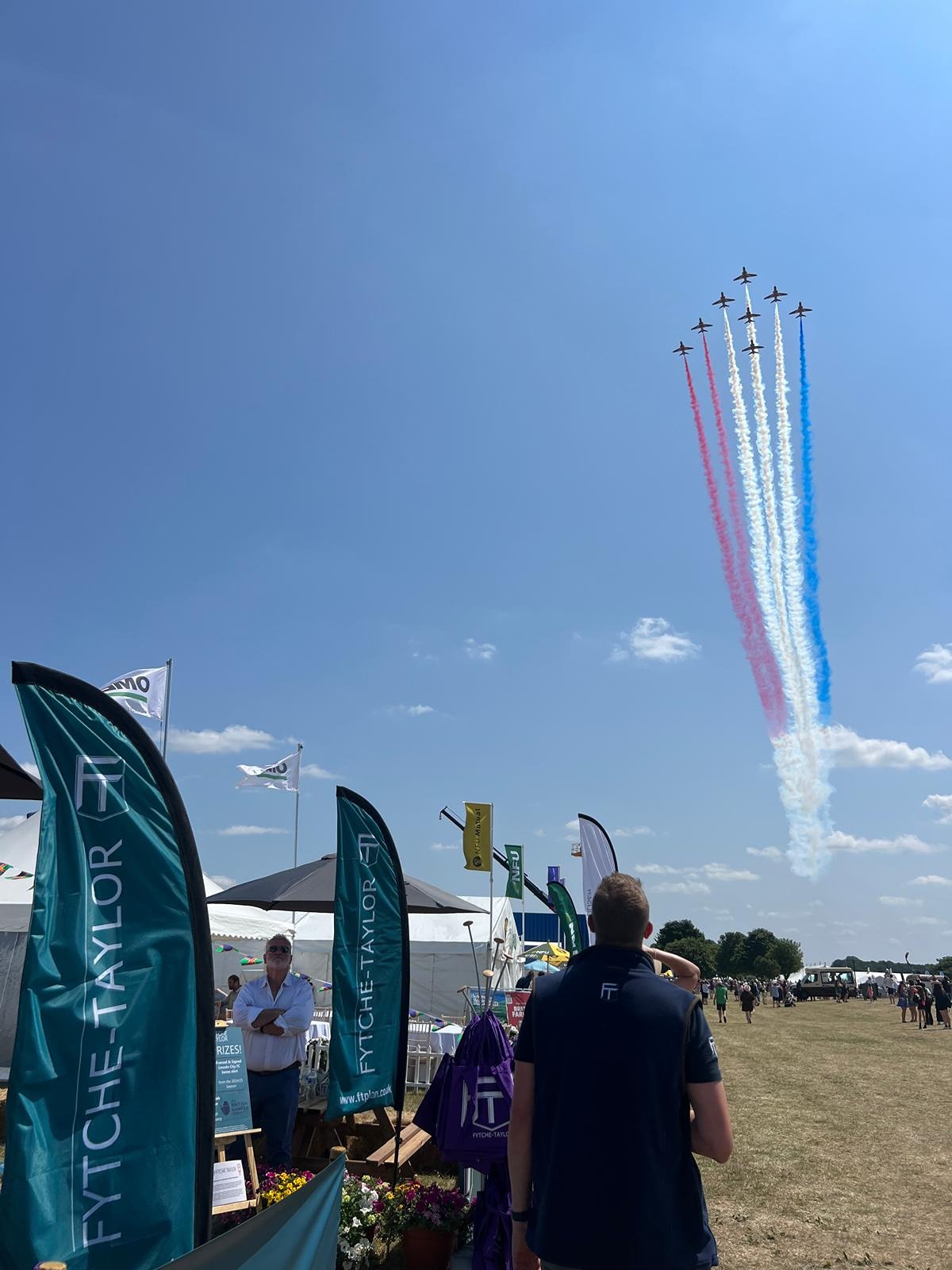 Red Arrows flypast above the Fytche-Taylor Planning stand at the Lincolnshire Showground during the Lincolnshire Show