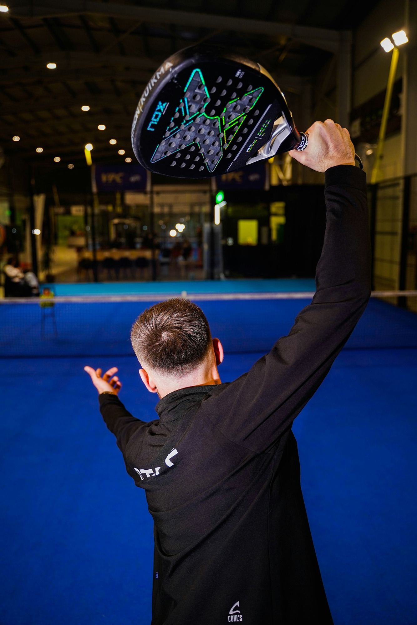 man-holding-a-padel-racket-over-head-cosoQpE-4iM.jpg