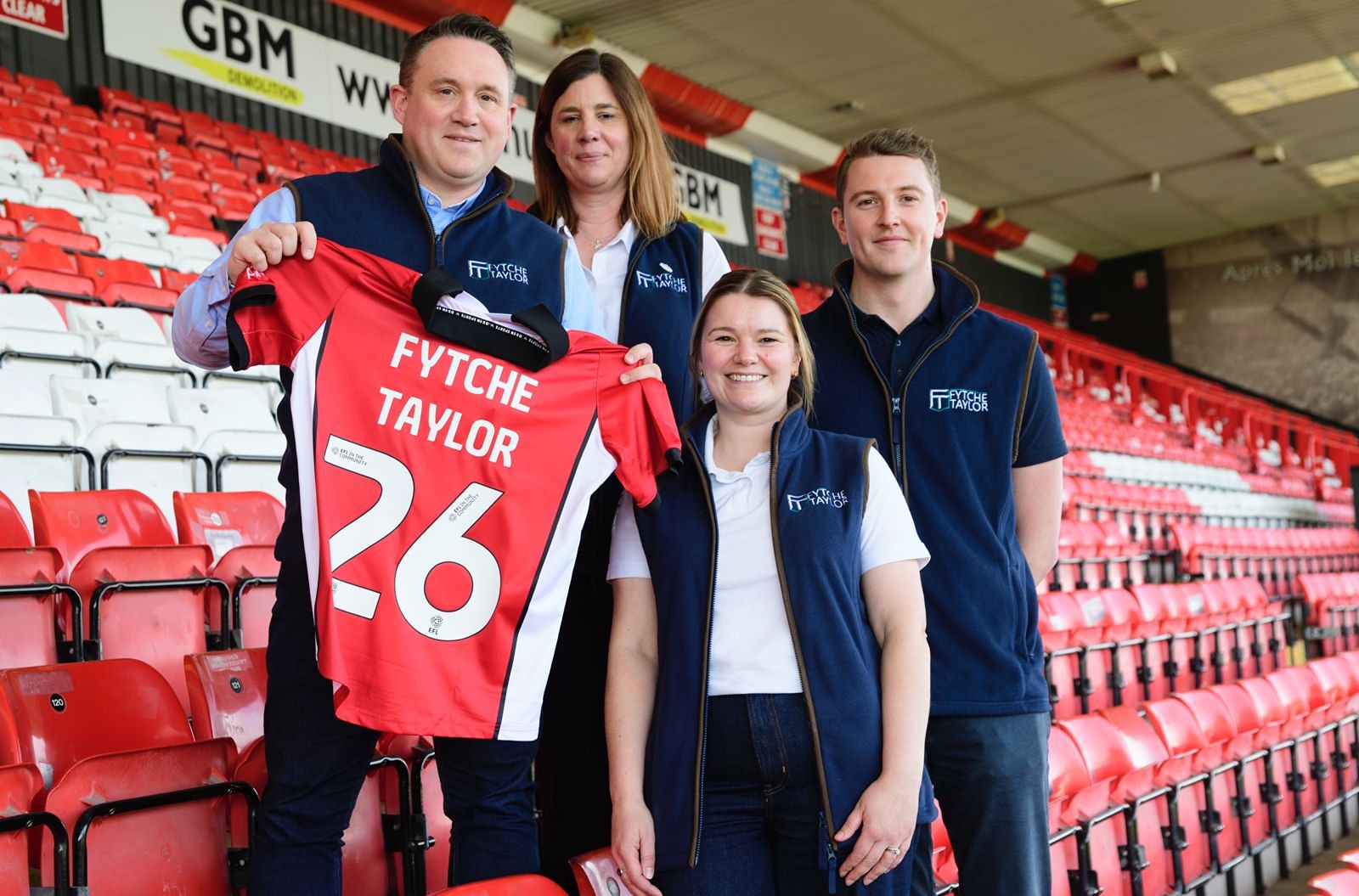 LCFC Defender Regan Poole presents a signed shirt to Fytche-Taylor Planning Director Oliver. 