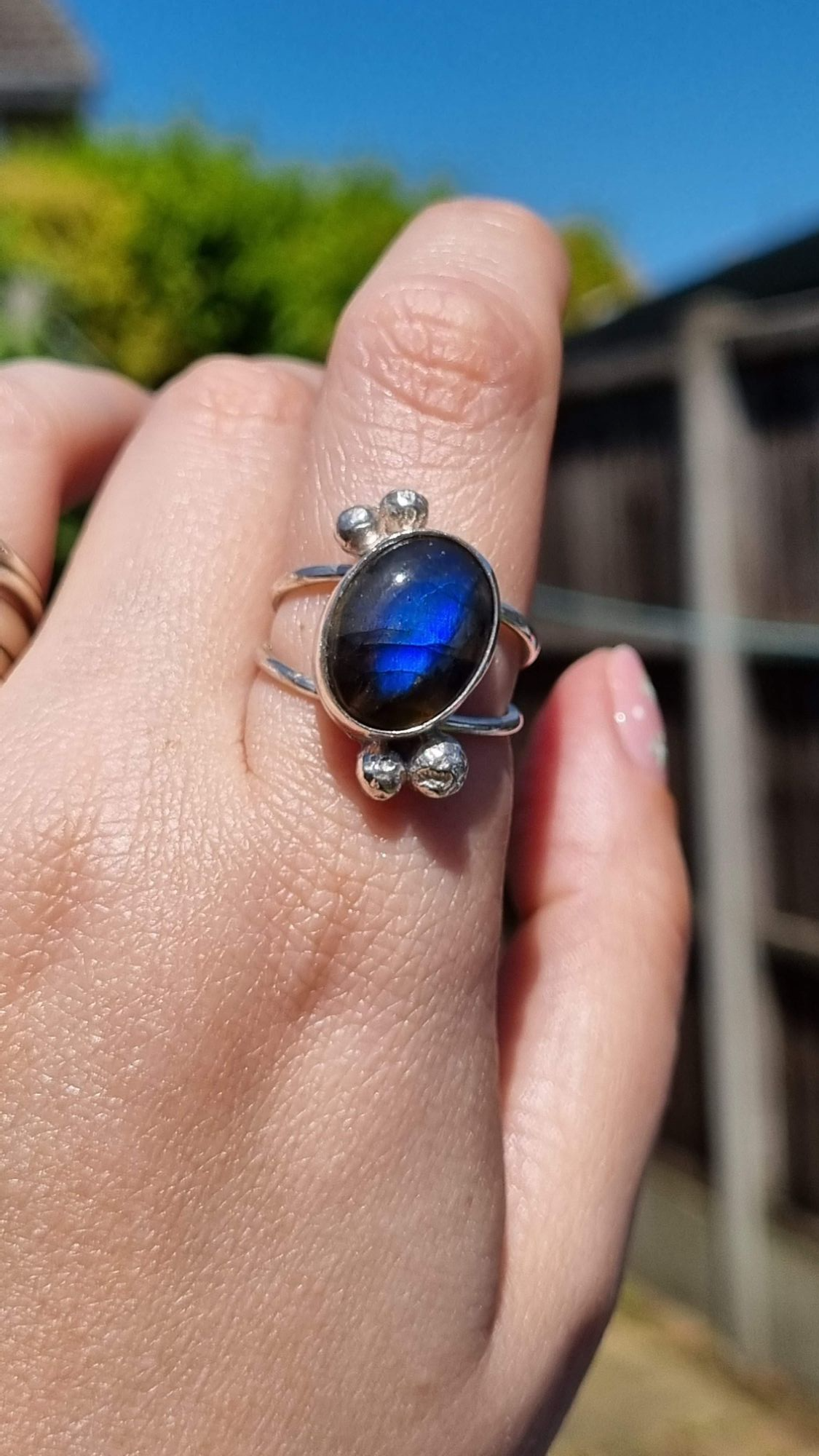 A beautiful handmade sterling silver gemstone statement ring featuring a flashy blue Labradorite gemstone
