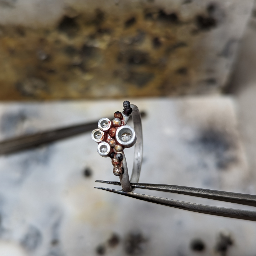 A top view of the ring in progress with the granulation and settings after soldering