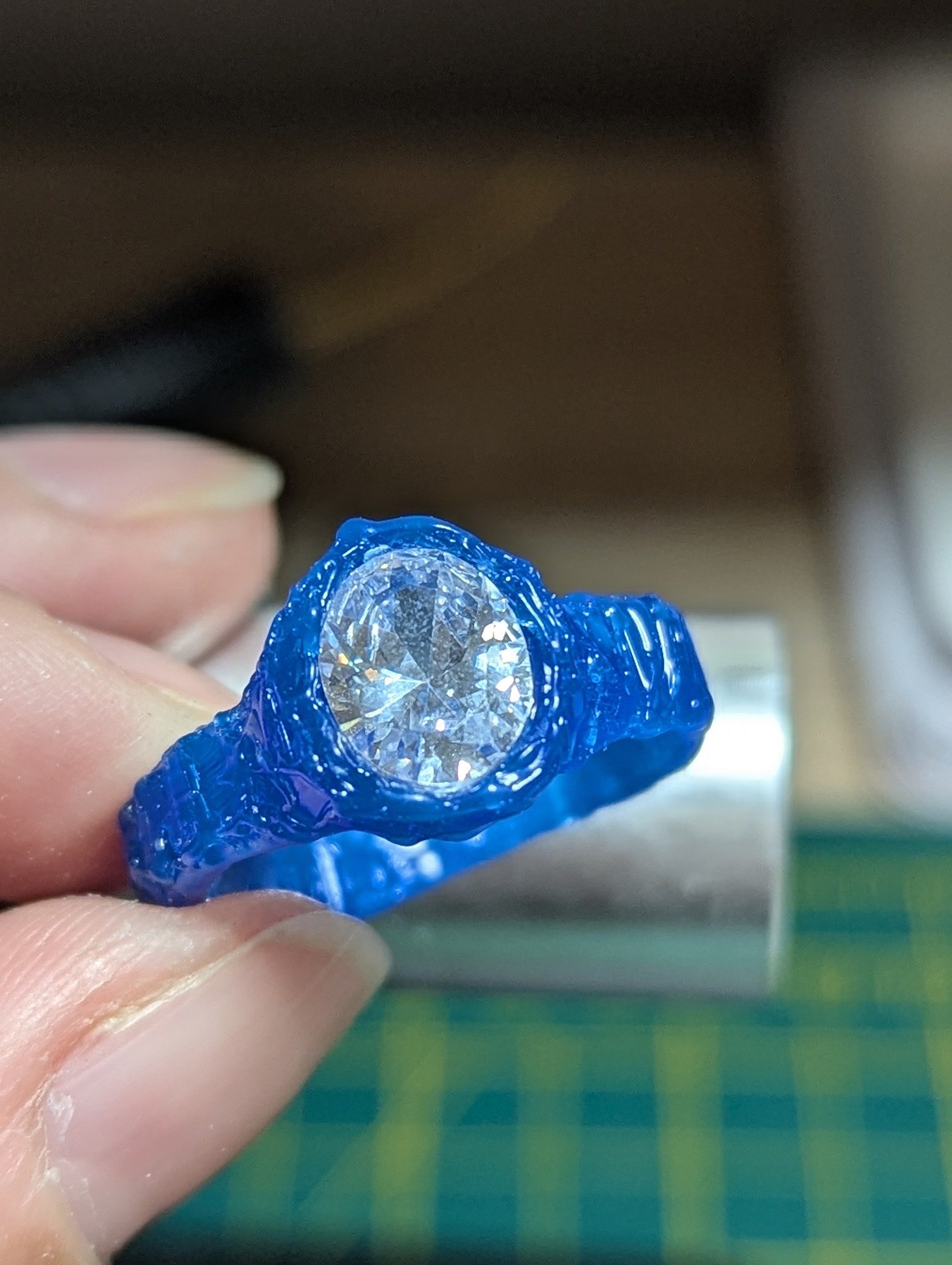a work in progress of a wax ring master with a CZ oval gemstone in the middle