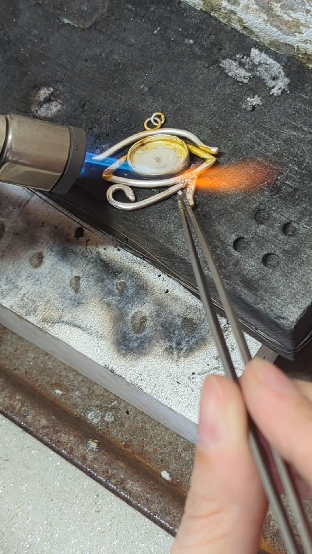 Soldering of a silver Eye of Horus Necklace