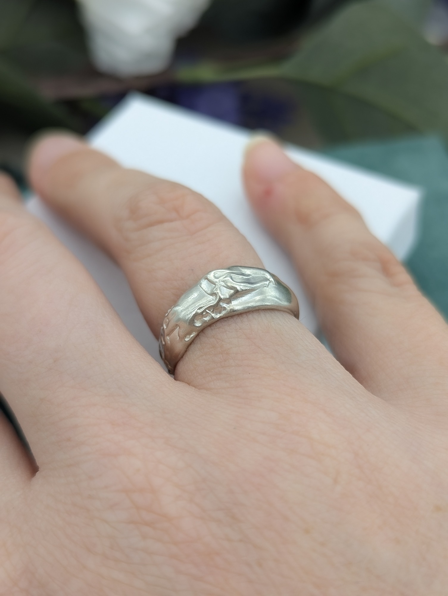 A sterling silver molten design ring being worn 
