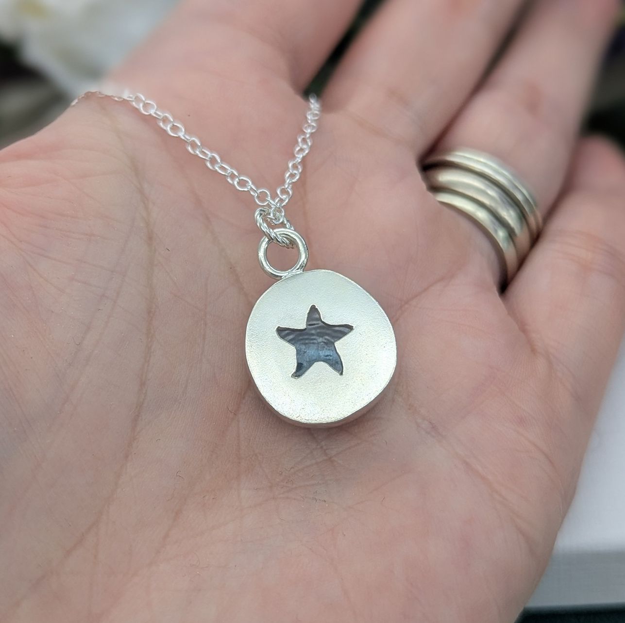 the reverse side of the starfish necklace showing the cut out starfish detail