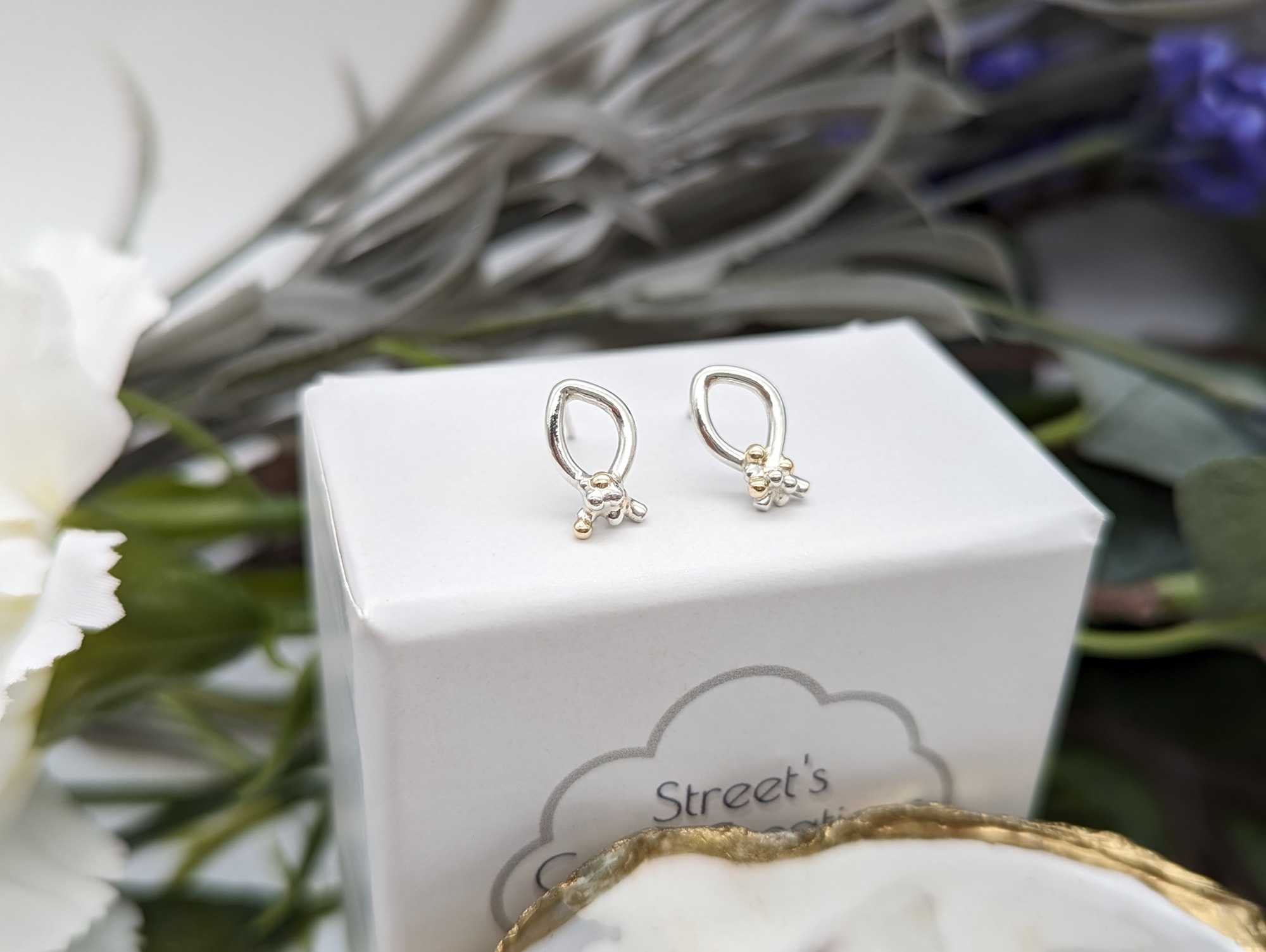 Silver & Gold granulation stud earrings on white jewellery box 