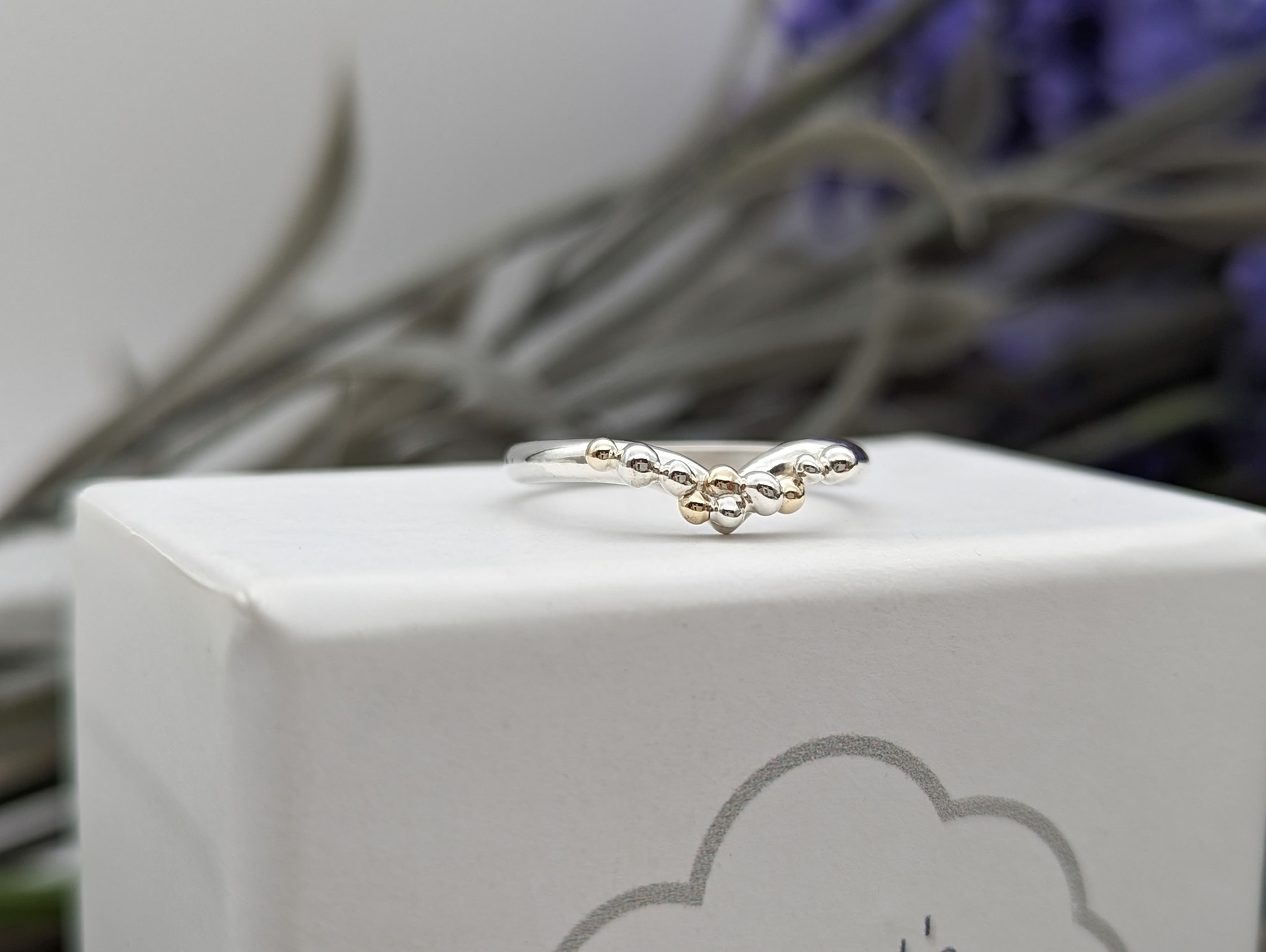 Silver & Gold granulation wishbone ring on a white jewellery box